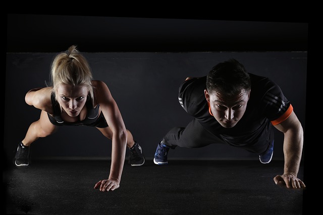 a man and woman doing push ups